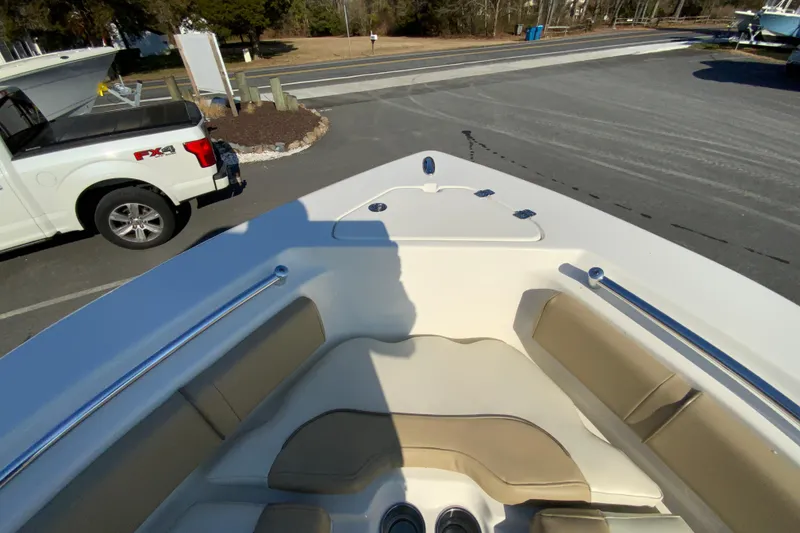Slide: The Image of 2019 Key West 239 FS boat bow with seating, parked near a white truck. - 25