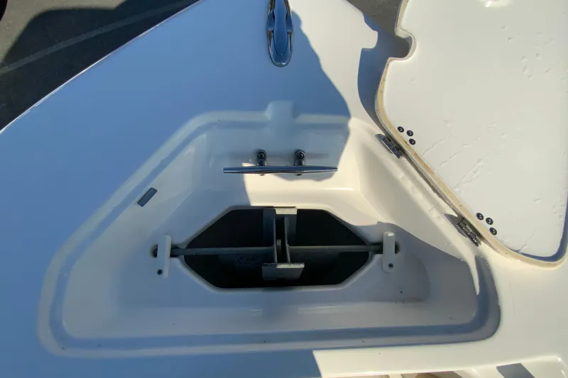 Slide: The Image of 2019 Key West 239 FS boat anchor storage compartment, open lid, white interior. - 26