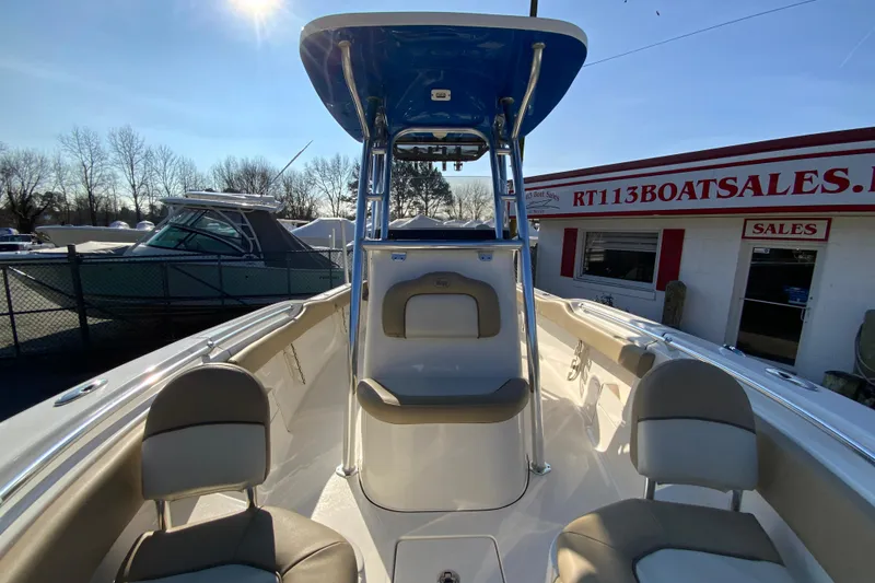 Slide: The Image of 2019 Key West 239 FS boat at dealership, showcasing seating and console. - 27