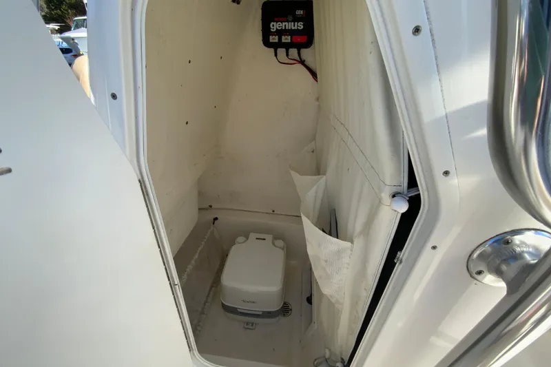 Slide: The Image of 2019 Key West 239 FS boat interior with portable toilet and storage compartment. - 31