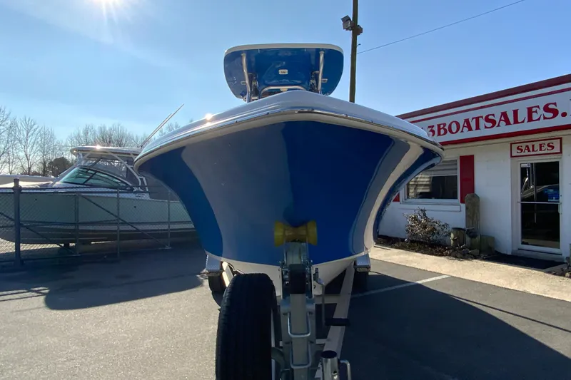 Slide: The Image of 2019 Key West 239 FS boat on trailer at dealership under clear sky. - 4