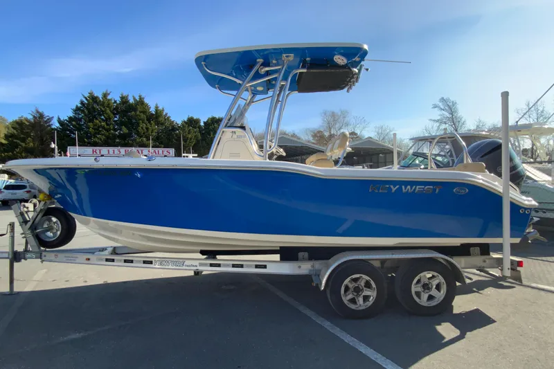 Slide: The Image of 2019 Key West 239 FS boat on trailer, blue hull, outdoor display. - 6