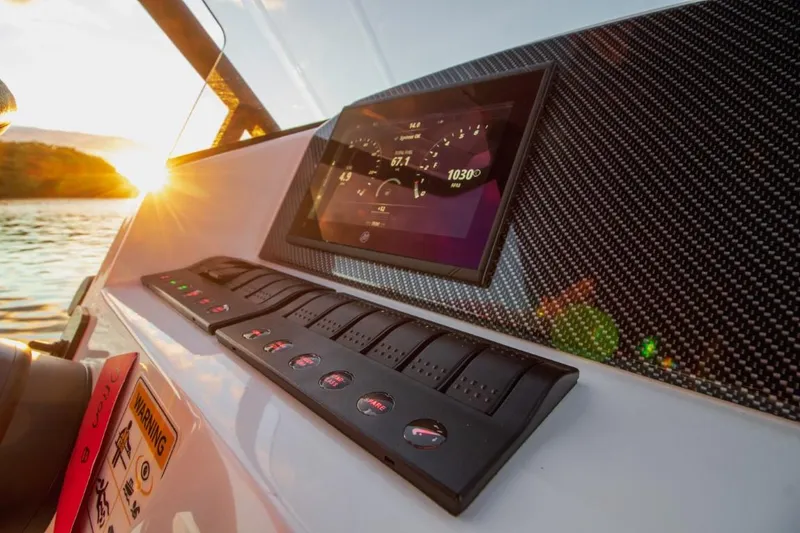 Slide: The Image of 2024 Northstar Orion 8 boat dashboard with touchscreen and control panel at sunset. - 11