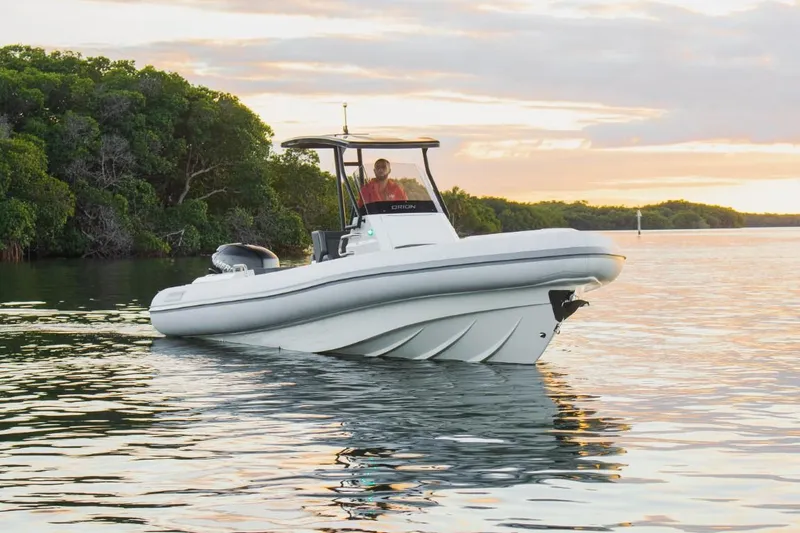 Slide: The Image of 2024 Northstar Orion 8 boat cruising on calm waters at sunset. - 4