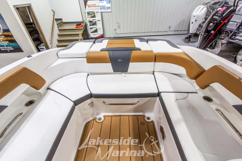 Slide: The Image of 2026 Chaparral 23 SSi boat interior with tan and white seating at Lakeside Marina. - 14