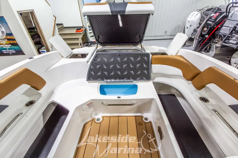 Slide: The Image of 2026 Chaparral 23 SSi boat interior with open storage compartment at Lakeside Marina. - 16