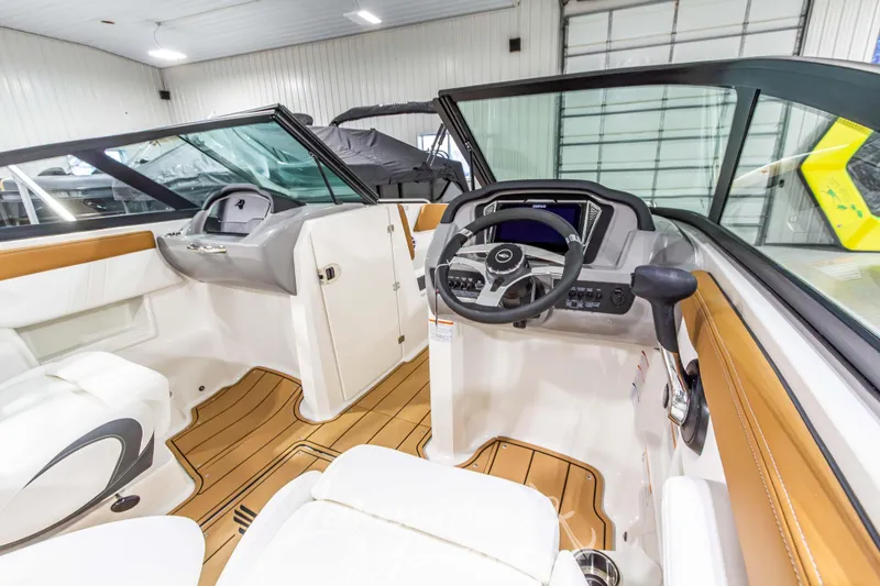 Slide: The Image of Interior of 2026 Chaparral 23 SSi boat with modern dashboard and steering wheel. - 21