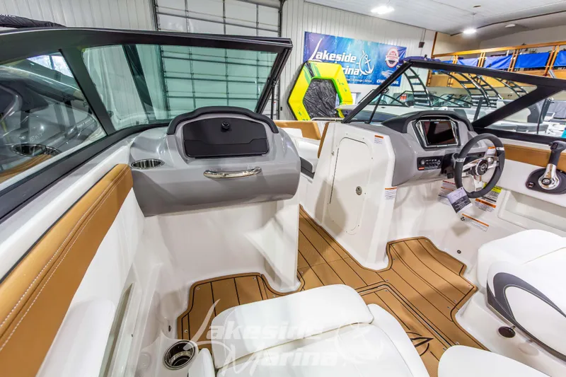 Slide: The Image of 2026 Chaparral 23 SSi boat interior with modern dashboard and seating. - 23