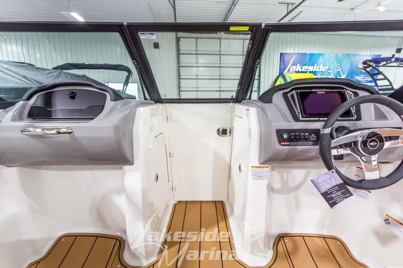 Slide: The Image of 2026 Chaparral 23 SSi boat interior with modern dashboard and steering wheel. - 25