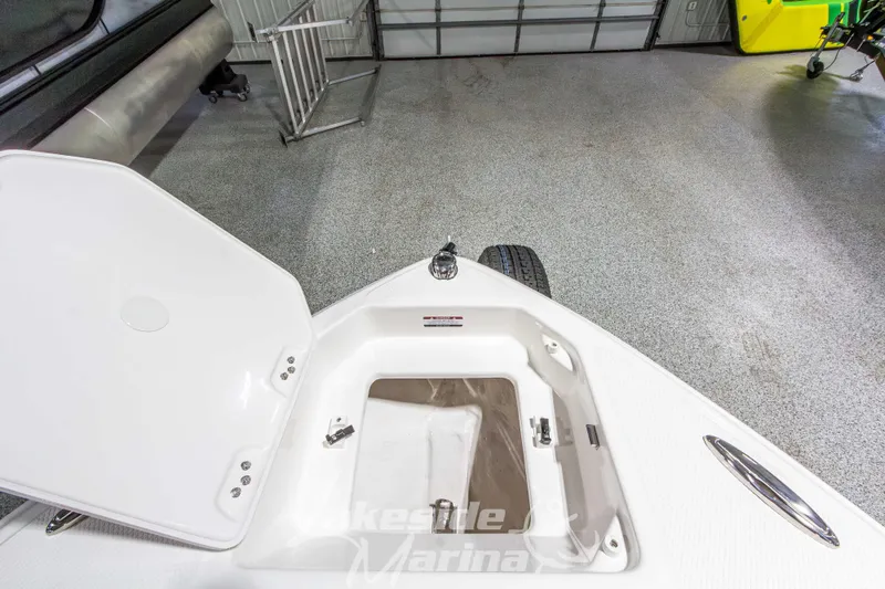 Slide: The Image of Open storage compartment on 2026 Chaparral 23 SSi boat in marina setting. - 33