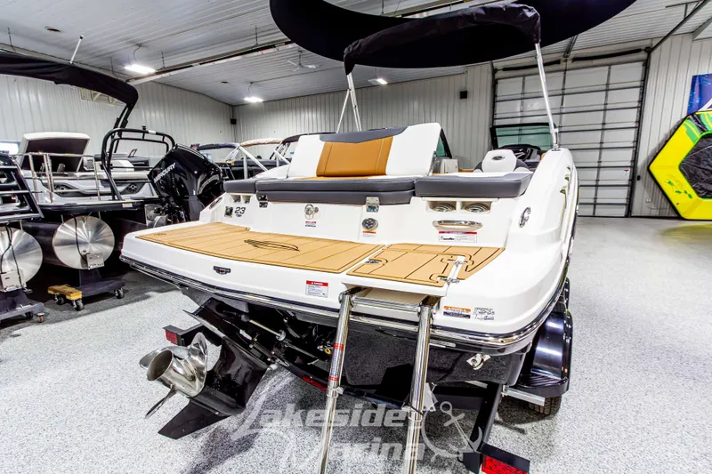 Slide: The Image of 2026 Chaparral 23 SSi boat in showroom, rear view with swim platform and ladder. - 4