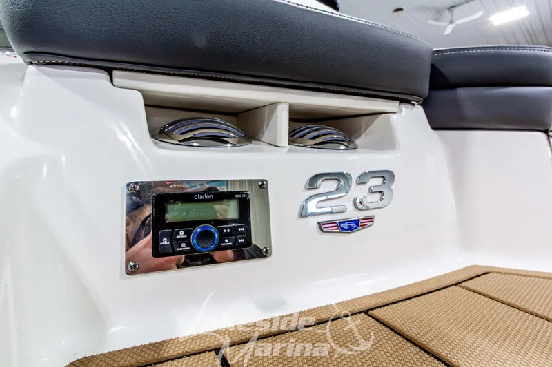 Slide: The Image of 2026 Chaparral 23 SSi boat interior with Clarion audio system and stylish seating. - 9