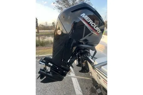 Slide: The Image of 2024 Tahoe T16 with Mercury outboard motor, parked outdoors. - 5