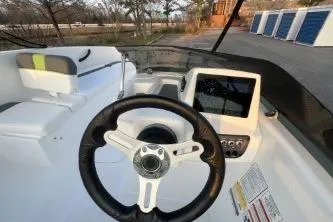 Slide: The Image of 2024 Tahoe T16 boat dashboard with steering wheel and digital display. - 6