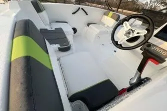 Slide: The Image of 2024 Tahoe T16 boat interior with modern seating and steering wheel design. - 7