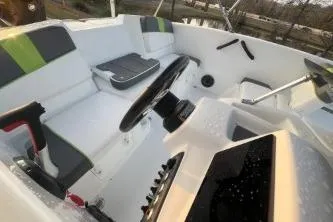 Slide: The Image of 2024 Tahoe T16 boat interior with steering wheel and seating. - 9