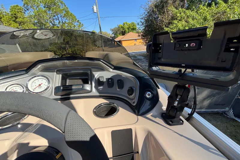 Slide: The Image of 2019 Sun Tracker Party Barge 20 DLX dashboard with steering wheel and control panel. - 22