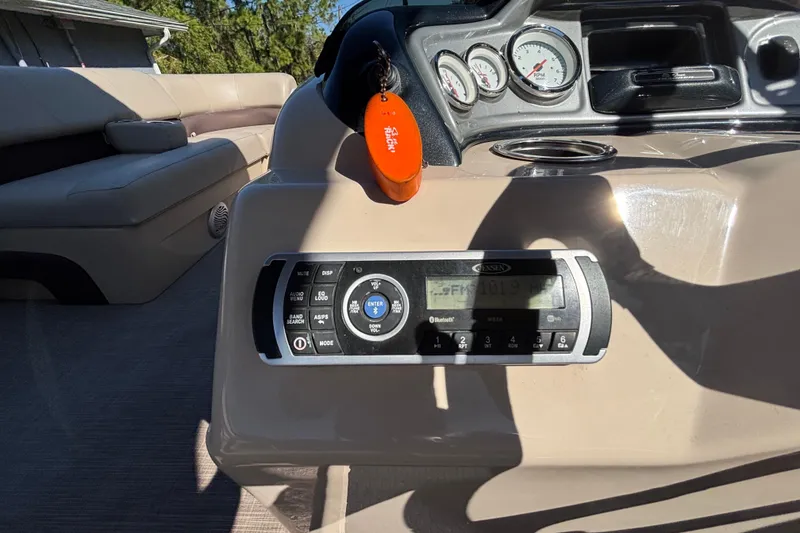 Slide: The Image of 2019 Sun Tracker Party Barge 20 DLX dashboard with stereo and gauges. - 23
