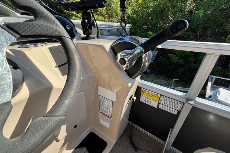 Slide: The Image of 2019 Sun Tracker Party Barge 20 DLX steering console with throttle lever and control panel. - 26