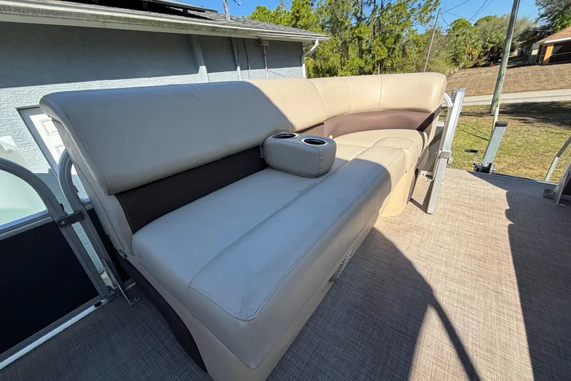 Slide: The Image of 2019 Sun Tracker Party Barge 20 DLX with beige seating and cup holders. - 29