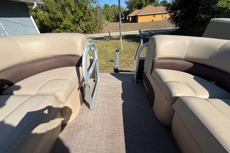 Slide: The Image of 2019 Sun Tracker Party Barge 20 DLX interior with beige seating and open deck. - 36