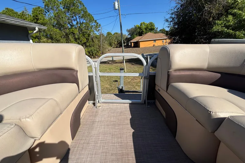 Slide: The Image of 2019 Sun Tracker Party Barge 20 DLX interior with beige and brown seating. - 37