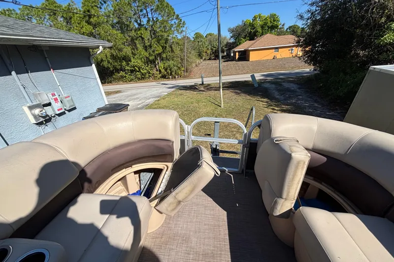Slide: The Image of 2019 Sun Tracker Party Barge 20 DLX interior with beige seating and open deck view. - 38