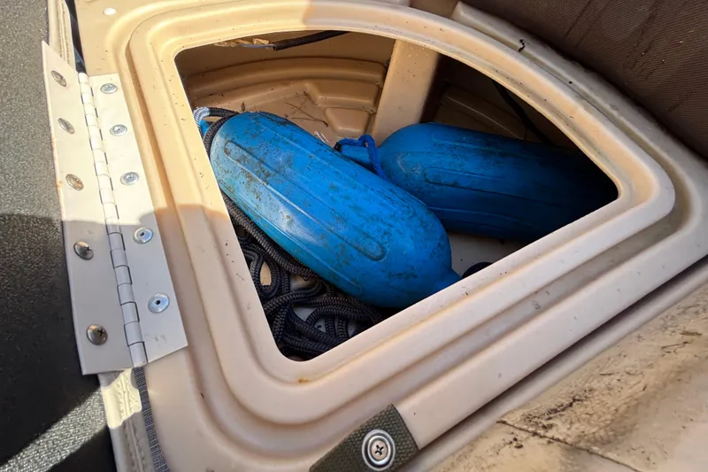 Slide: The Image of Storage compartment of 2019 Sun Tracker Party Barge 20 DLX with blue fenders. - 40