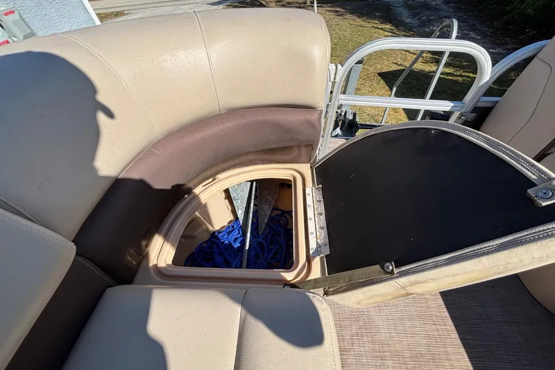 Slide: The Image of 2019 Sun Tracker Party Barge 20 DLX storage compartment with open seat revealing blue rope. - 41
