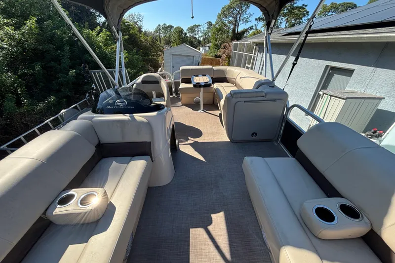 Slide: The Image of 2019 Sun Tracker Party Barge 20 DLX interior with spacious seating and cup holders. - 50