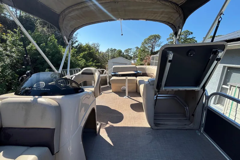 Slide: The Image of 2019 Sun Tracker Party Barge 20 DLX pontoon boat interior with canopy and seating. - 55