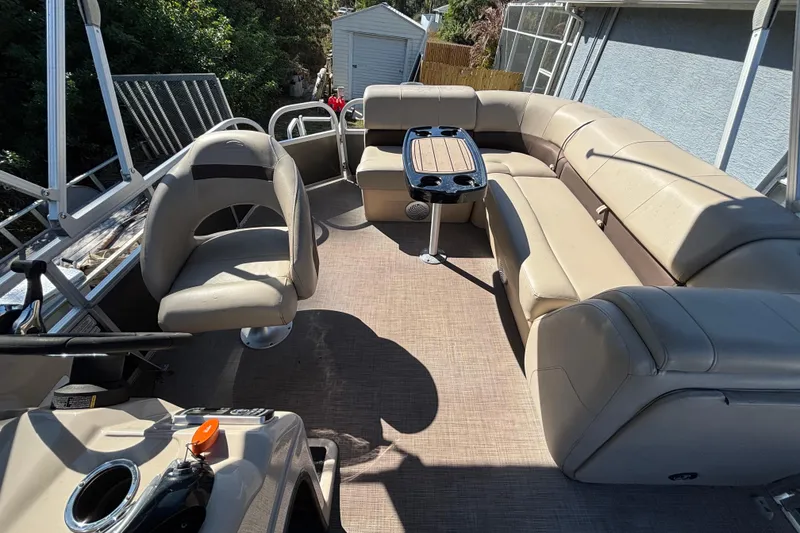 Slide: The Image of 2019 Sun Tracker Party Barge 20 DLX interior with beige seating and table. - 58