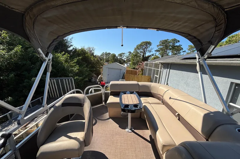 Slide: The Image of 2019 Sun Tracker Party Barge 20 DLX interior with seating and table, ideal for leisure. - 61