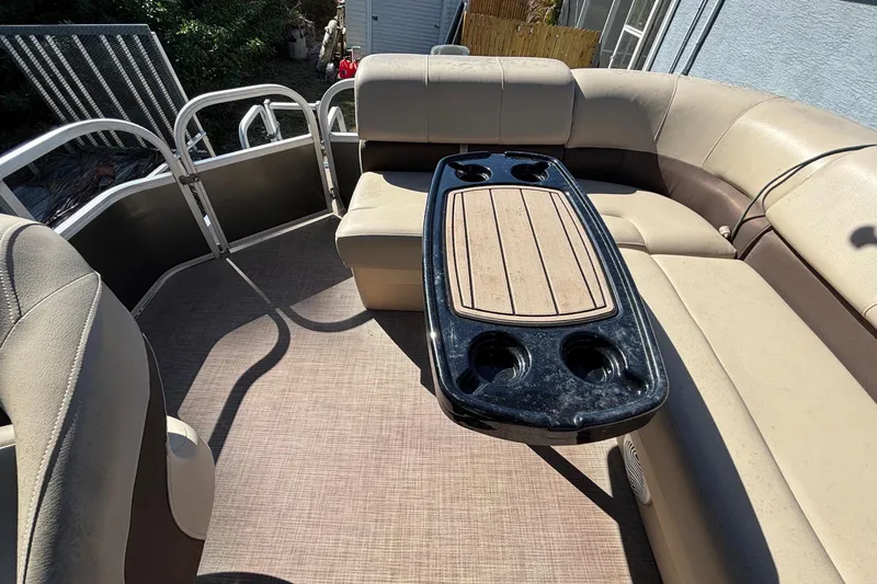 Slide: The Image of 2019 Sun Tracker Party Barge 20 DLX interior with beige seating and table. - 62