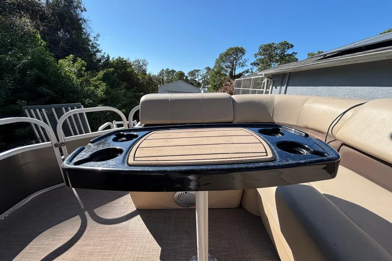 Slide: The Image of 2019 Sun Tracker Party Barge 20 DLX interior with seating and table, ideal for leisure. - 66