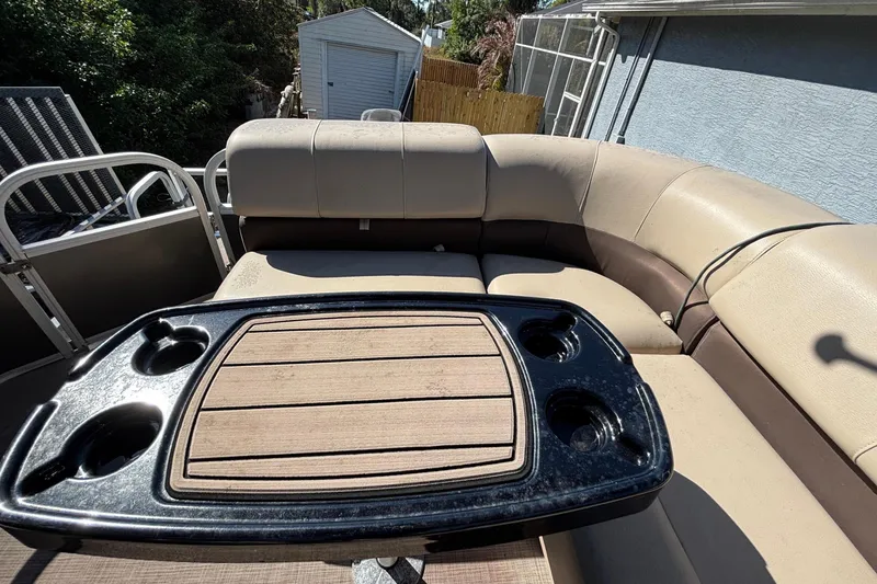 Slide: The Image of 2019 Sun Tracker Party Barge 20 DLX pontoon boat parked near a house and trees. - 68