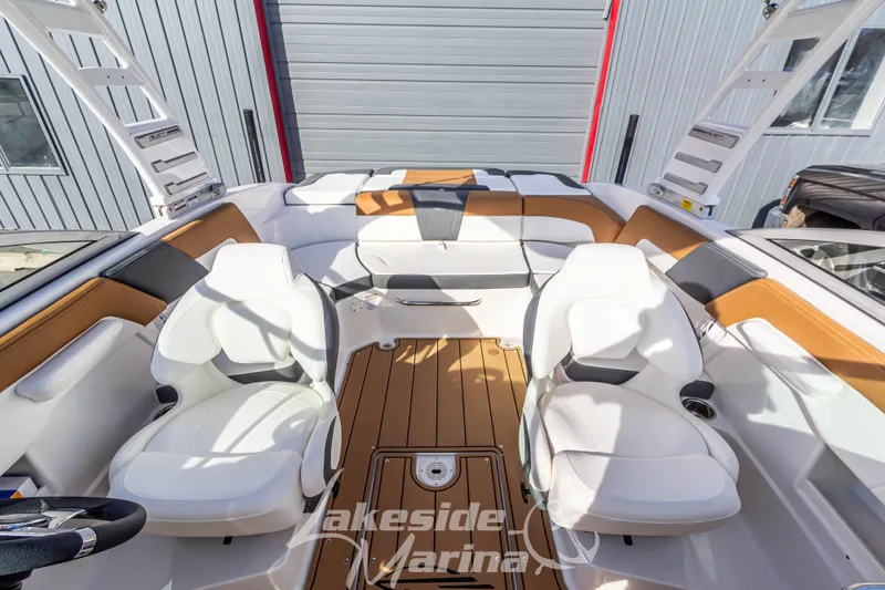 Slide: The Image of 2026 Chaparral 23 SSi boat interior with white seating and wood accents at Lakeside Marina. - 17