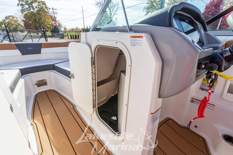Slide: The Image of 2026 Chaparral 23 SSi boat interior with open storage compartment and seating area. - 22
