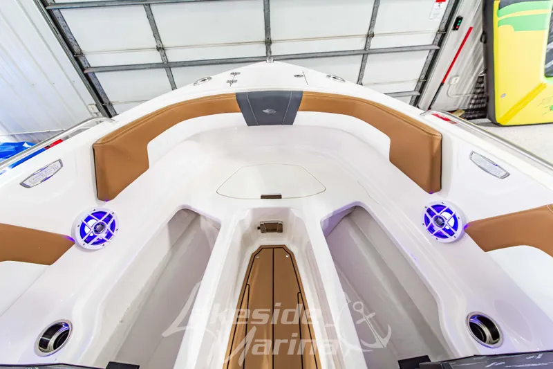 Slide: The Image of 2026 Chaparral 23 SSi boat interior with brown seating and blue LED speakers. - 32