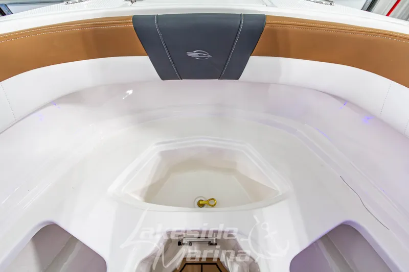Slide: The Image of 2026 Chaparral 23 SSi boat interior with tan and white seating, featuring a storage compartment. - 33