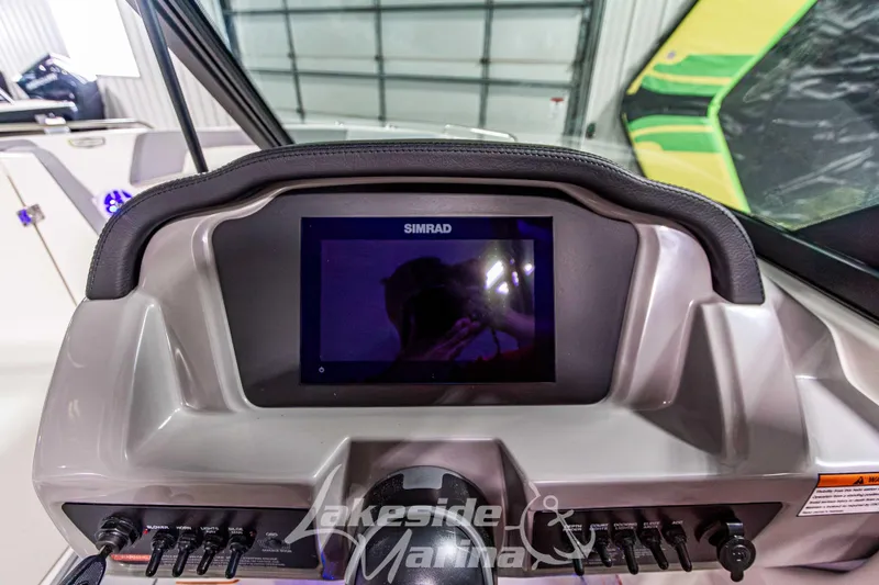 Slide: The Image of Dashboard of 2026 Chaparral 23 SSi boat with Simrad display and control panel. - 16