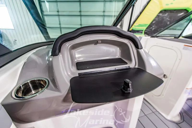 Slide: The Image of 2026 Chaparral 23 SSi boat interior with storage compartment and cup holder. - 18