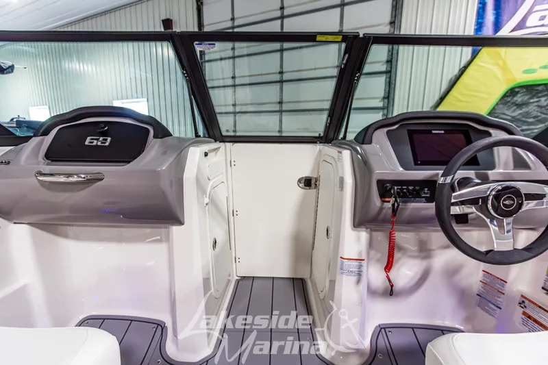 Slide: The Image of 2026 Chaparral 23 SSi boat interior with modern dashboard and steering wheel. - 19