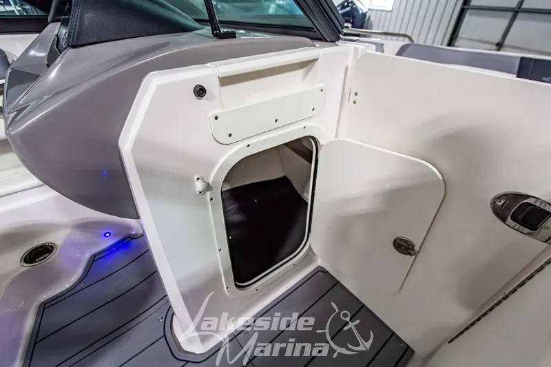 Slide: The Image of 2026 Chaparral 23 SSi boat interior storage compartment with open door. - 21