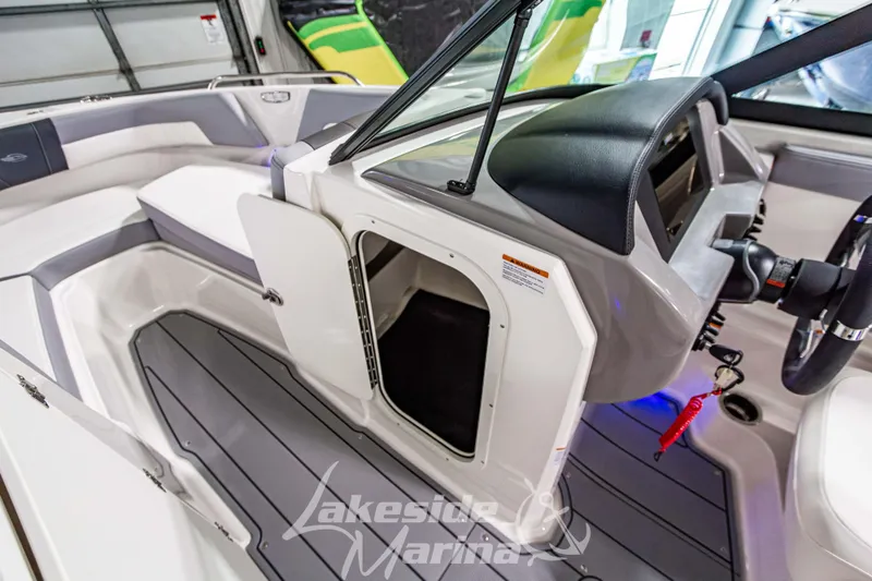 Slide: The Image of 2026 Chaparral 23 SSi boat interior with open storage compartment and sleek seating. - 22