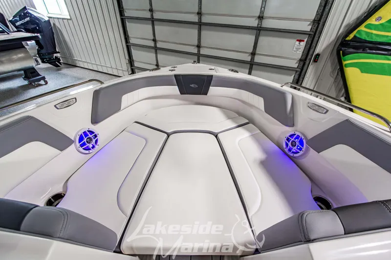 Slide: The Image of 2026 Chaparral 23 SSi boat interior with cushioned seating and blue LED lights. - 23