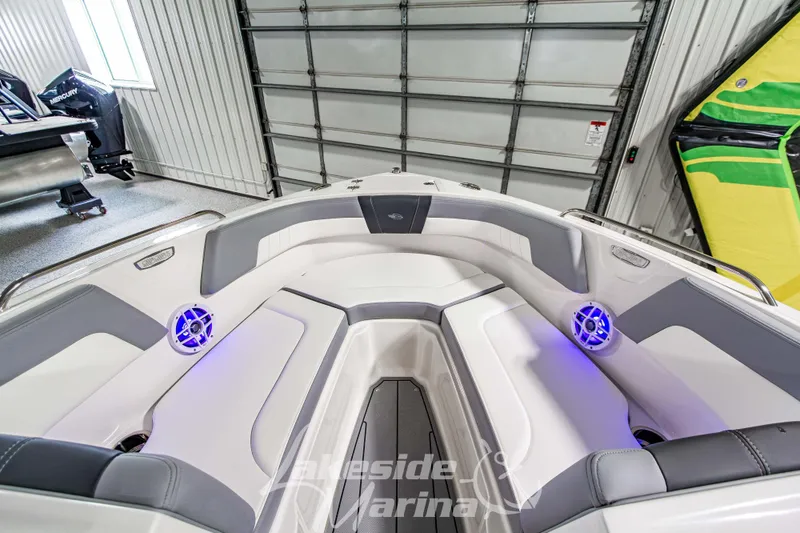 Slide: The Image of 2026 Chaparral 23 SSi boat interior with modern seating and blue LED lighting. - 24