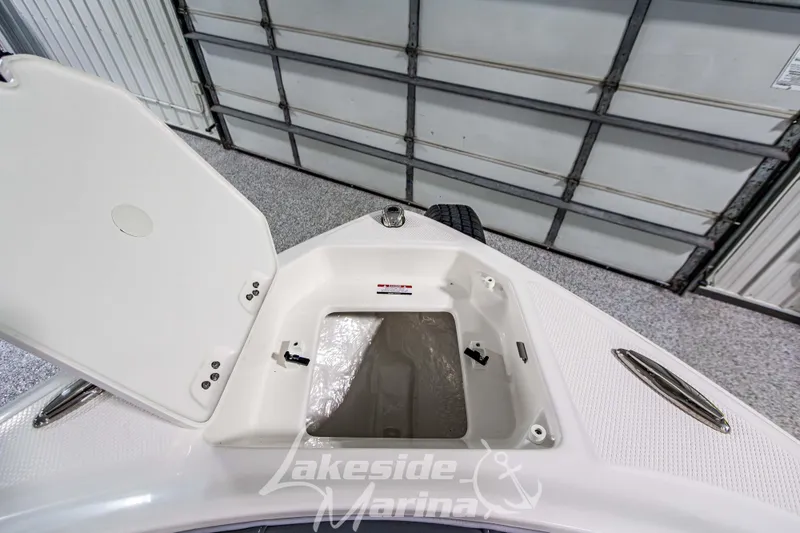 Slide: The Image of 2026 Chaparral 23 SSi boat storage compartment open at Lakeside Marina. - 27