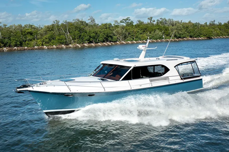 The Image of Manufacturer Provided Image: 2025 Hylas M49 yacht cruising on a sunny day, surrounded by lush greenery. - 0