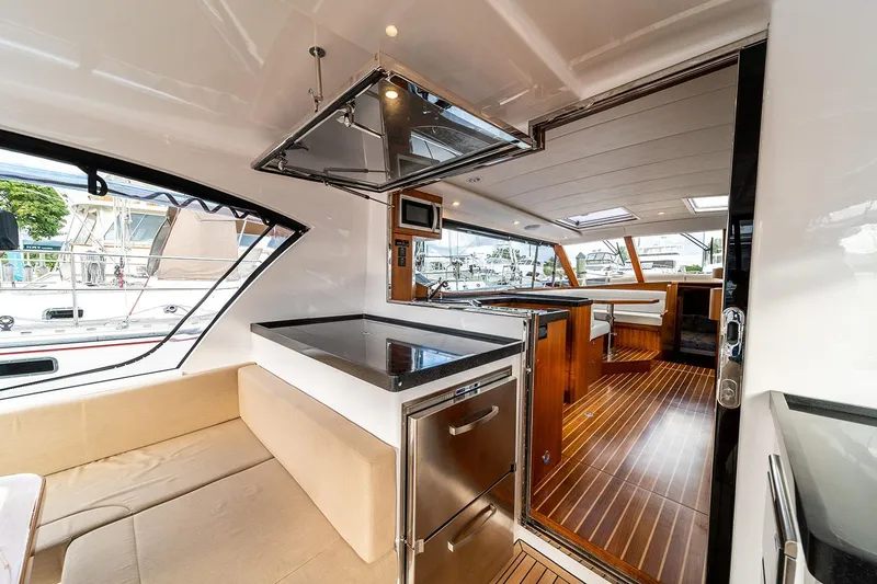 Slide: The Image of Manufacturer Provided Image: Luxurious interior of 2025 Hylas M49 yacht with modern kitchen and seating area. - 11